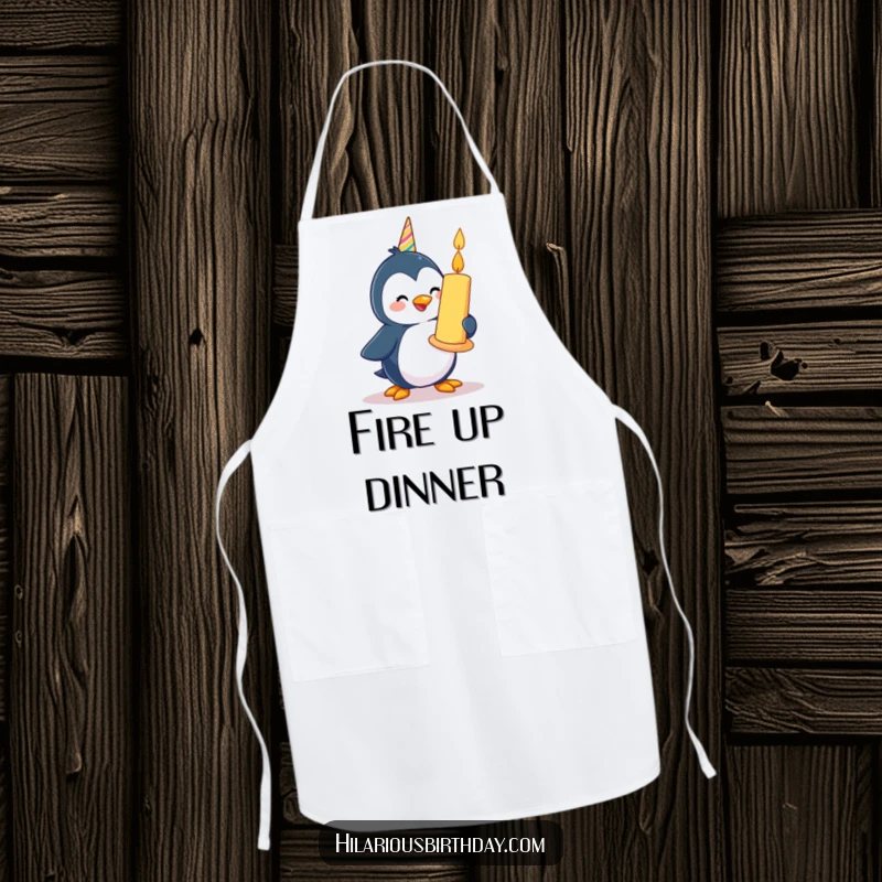 Funny happy penguin character waddling with a giant birthday candle, on a functional kitchen apron.
