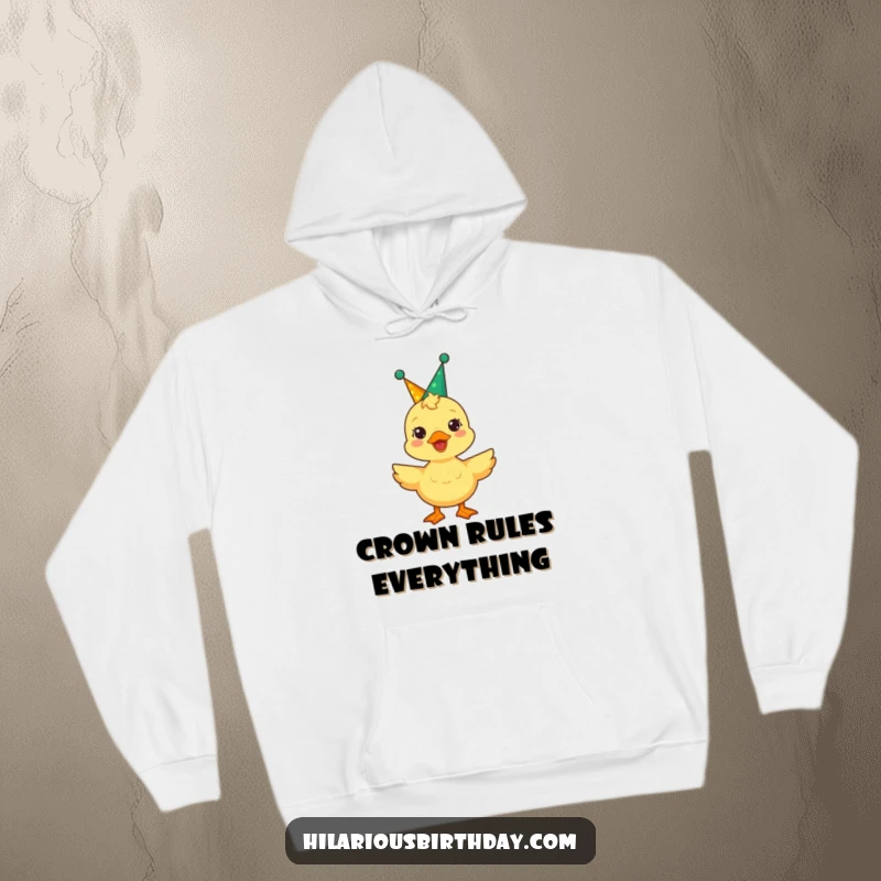 Funny duckling adorned with a party crown quacks gleefully on this hoodie, a symbol of joy and comfort.