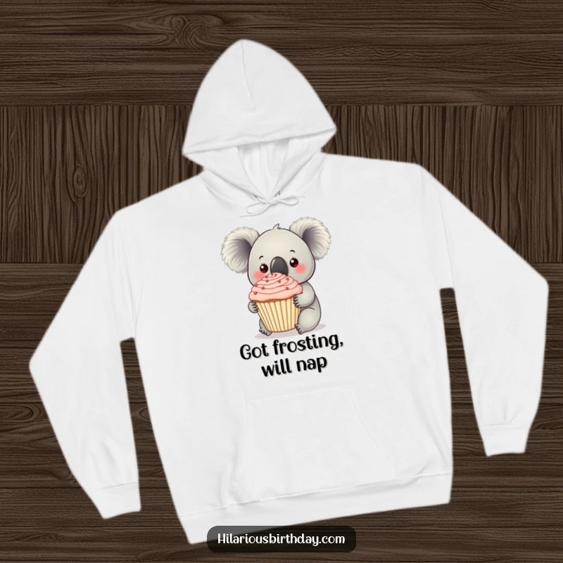 Funny curious koala clutches a giant frosted cupcake on this hoodie, a cozy symbol of sweet indulgence.