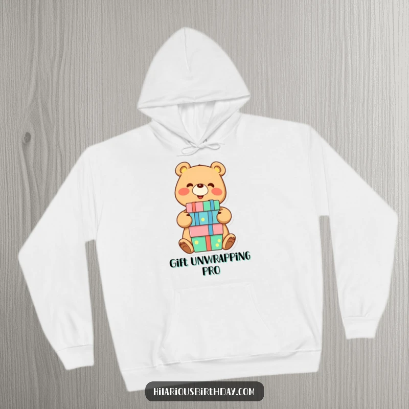 Funny hoodie with a smiling bear character joyfully balancing a stack of presents, offering cozy comfort and a humorous, festive vibe.
