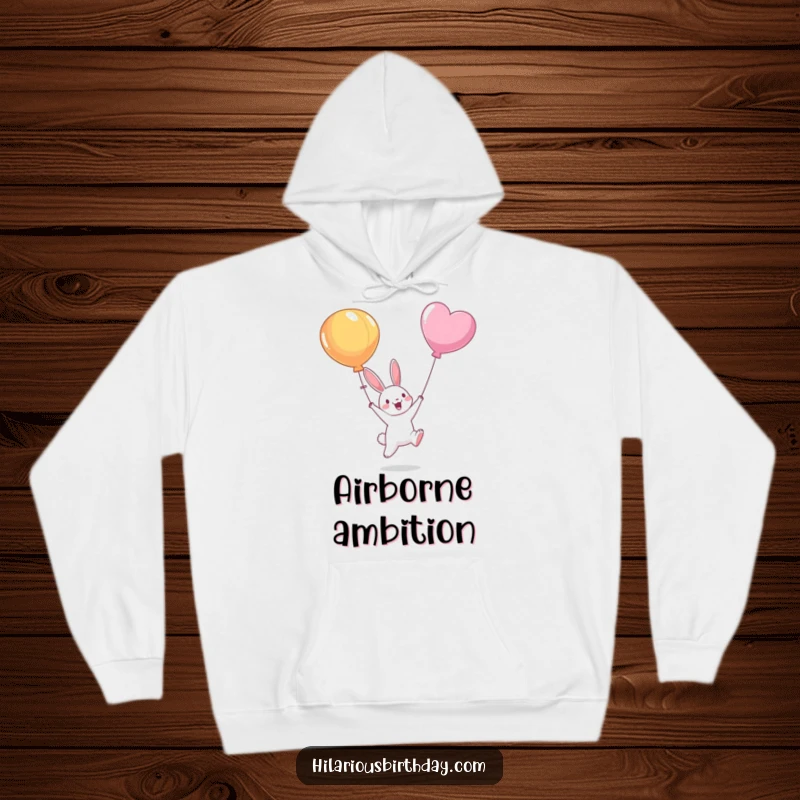 Funny hoodie featuring an animated bunny character leaping energetically to catch a balloon floating away, symbolizing aspirations and lightheartedness.