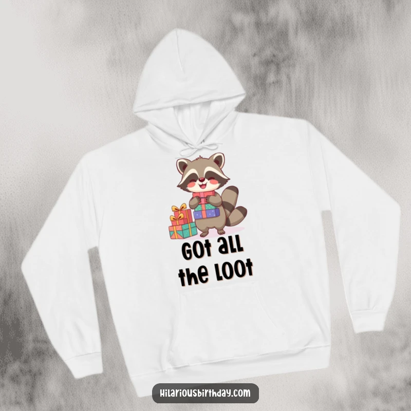 Funny hoodie featuring a joyful raccoon character balancing a stack of presents, offering cozy comfort and festive cheer.