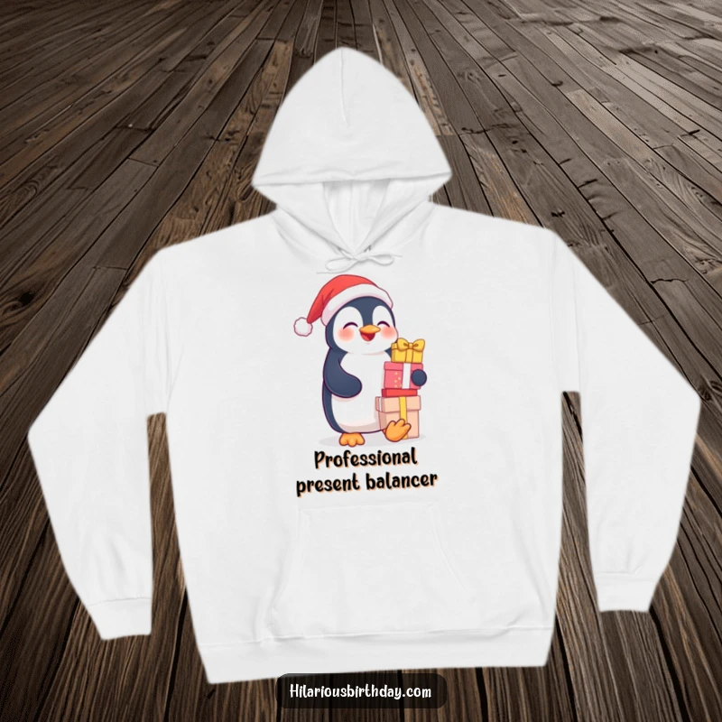 Funny hoodie: a cute, giggling penguin precariously balancing a huge stack of wrapped gifts, radiating happiness.