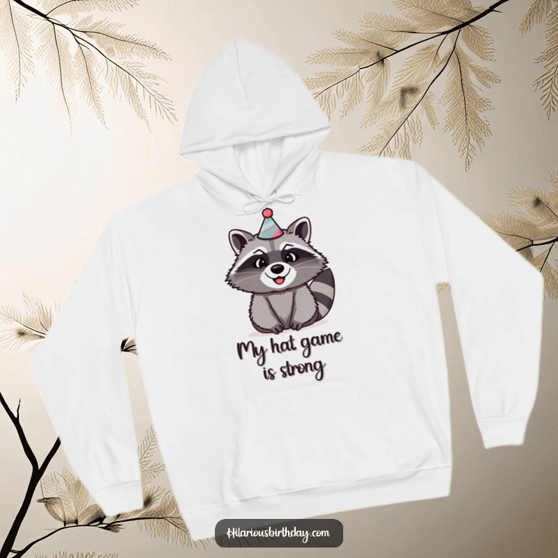 Funny raccoon hoodie showcasing a beaming raccoon with a wide smile, wearing a silly, oversized party hat.