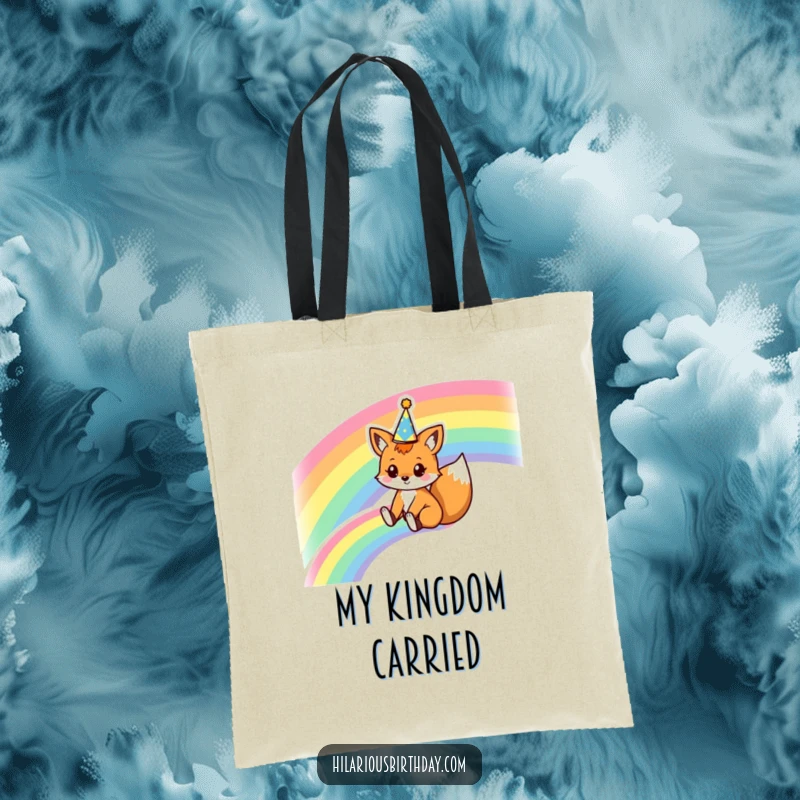 Funny tote bag with a kawaii fox character sliding down a rainbow wearing a party crown, perfect for carrying items with a magical style.